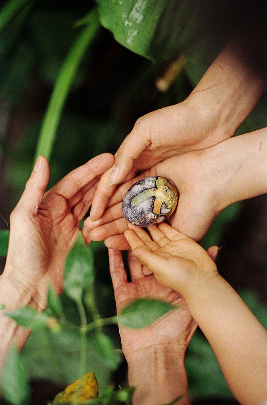 My mom, my sister and my son holding an egg we found